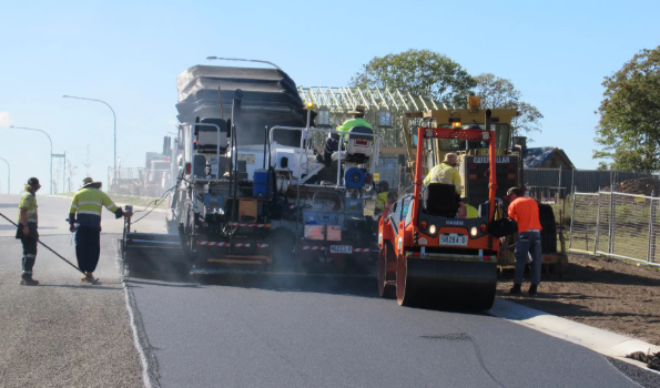Asphalt paving crew and roller on a commercial car park