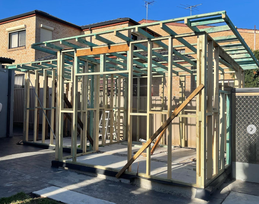 Carpentry: timber wall and roof framing for a small structure on site